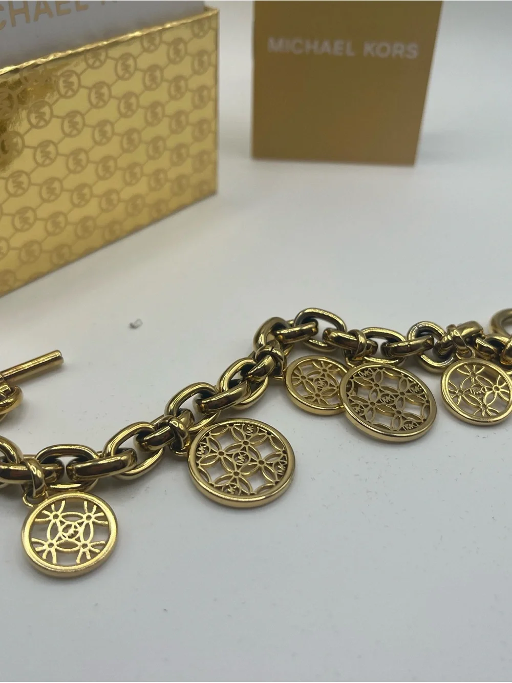 Michael Kors Gold Tone Charm Toggle Bracelet MK Logo Medallion NWT in Box